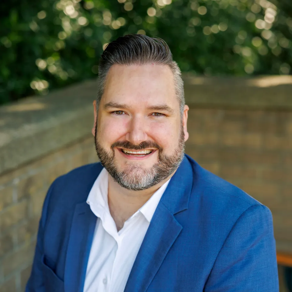 Callan Morrison, Port Moody City Councillor, smiling in a blue blazer.